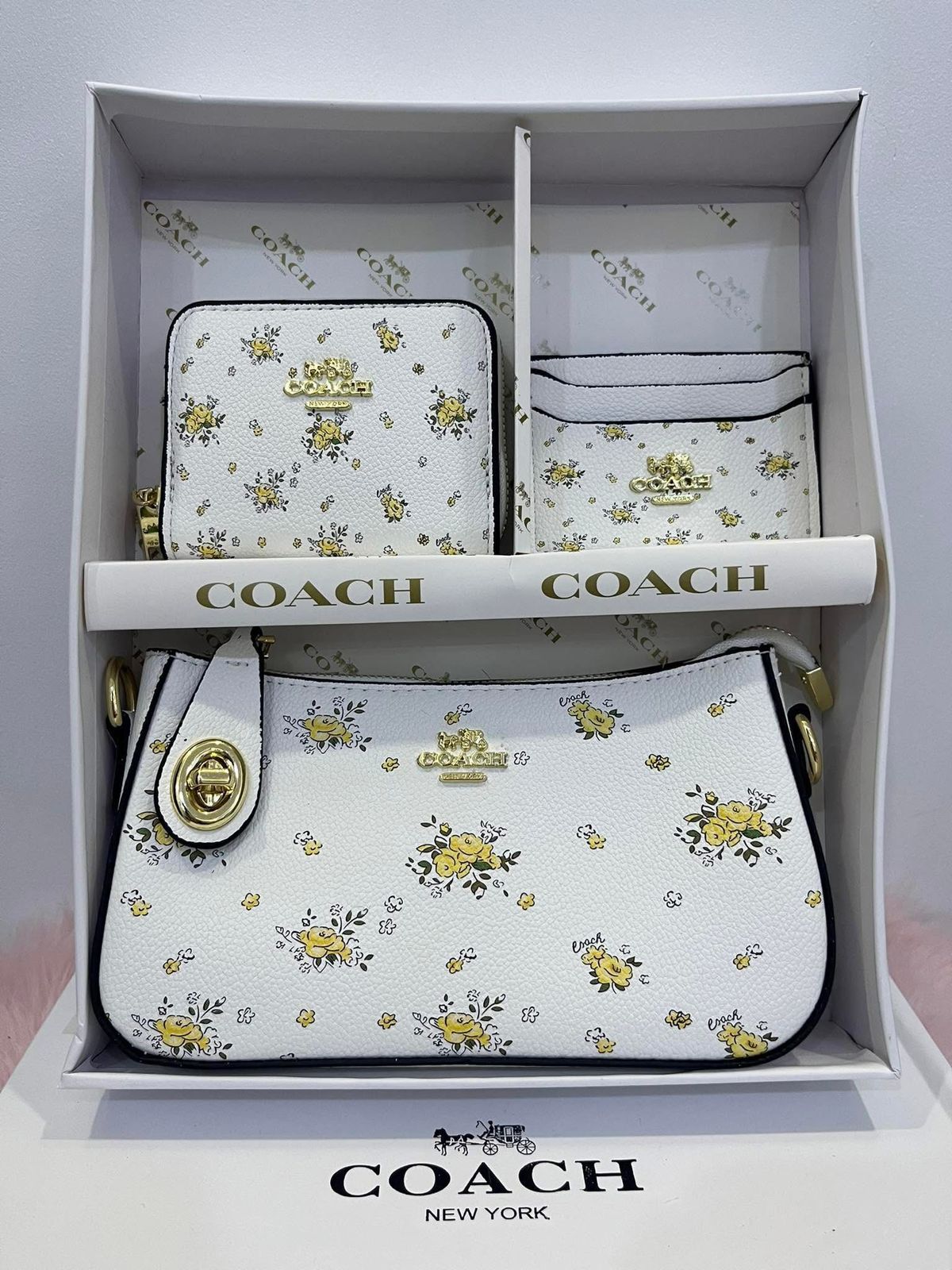 Coach handbag set with floral pattern in a box on a light gray background